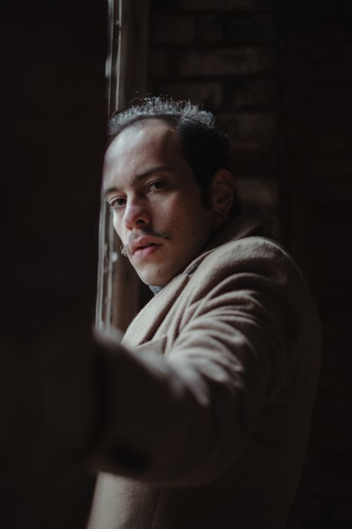 Free Moody portrait of a man in a coat looking out in Istanbul. Stock Photo