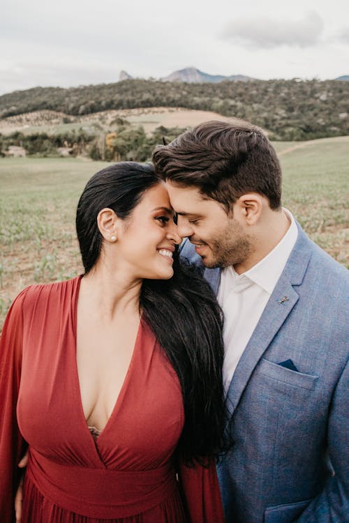 Cheerful Indian newlywed couple in stylish apparel in countryside