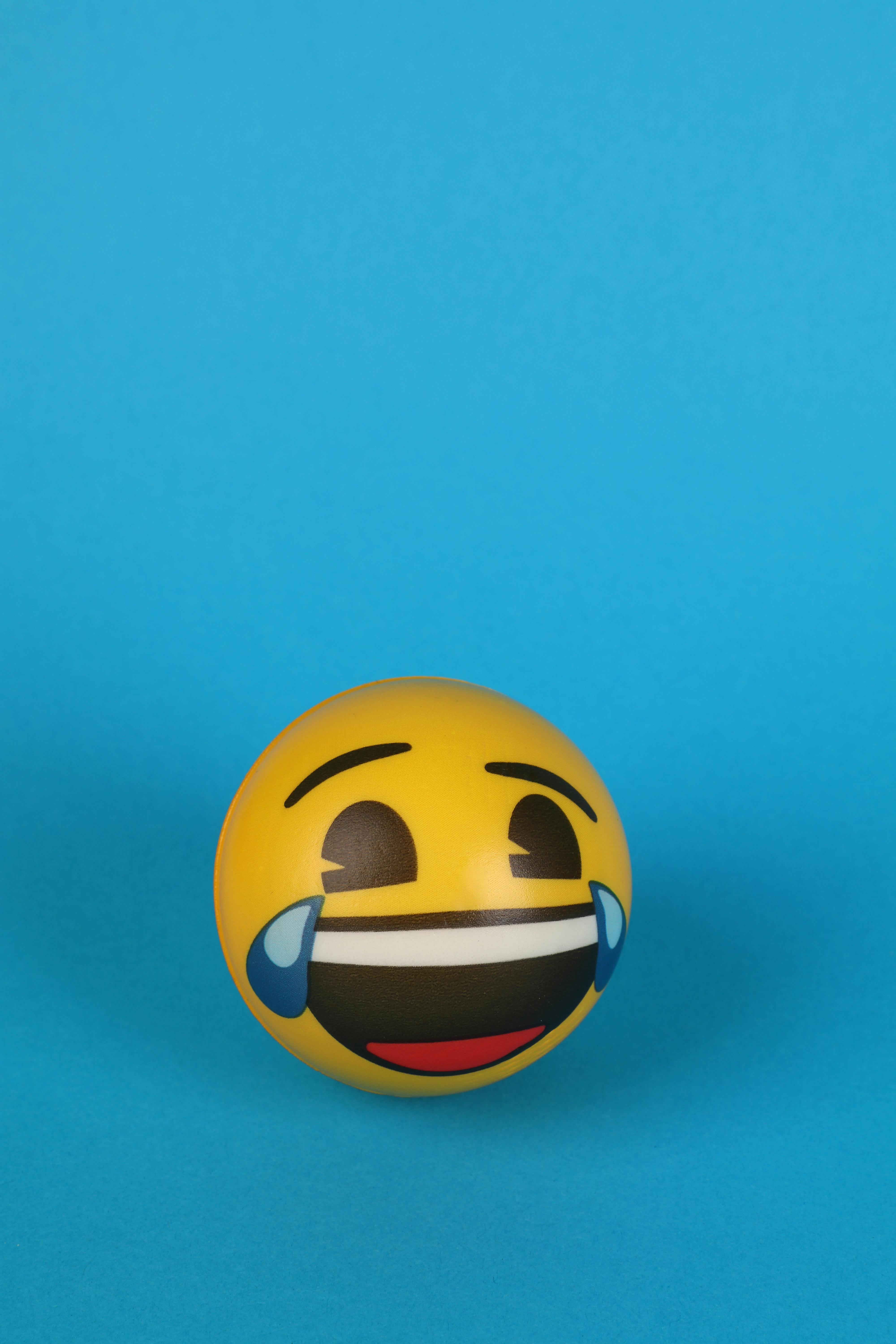 A Laughing Emoji with tears over Blue Surface · Free Stock Photo