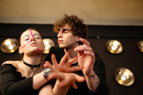 A Man and a Woman Wearing art Makeup