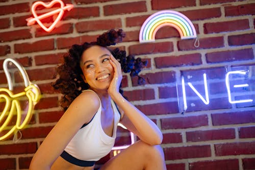 Pretty Woman Posing Near Neon Signs