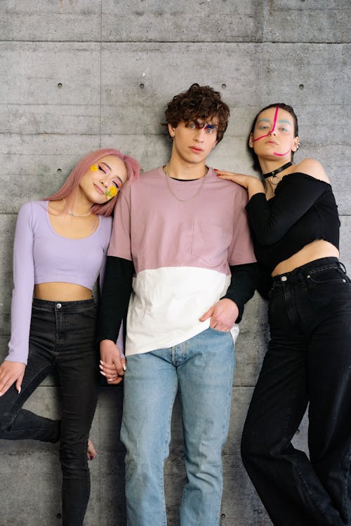 A Man and Two Women Posing Together for a Photoshoot