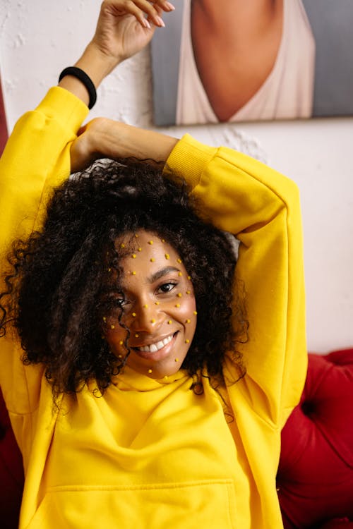 A Smiling Woman Wearing Yellow Sweater