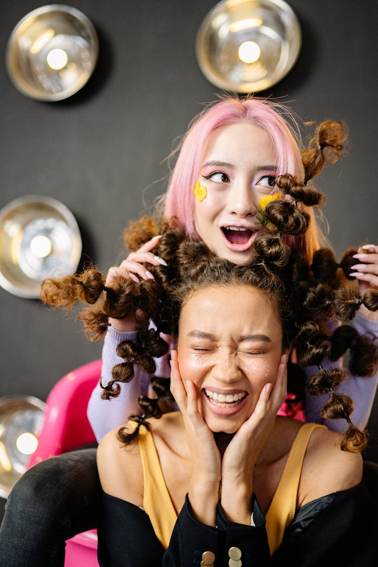 Two Young Women Laughing And Making Faces 