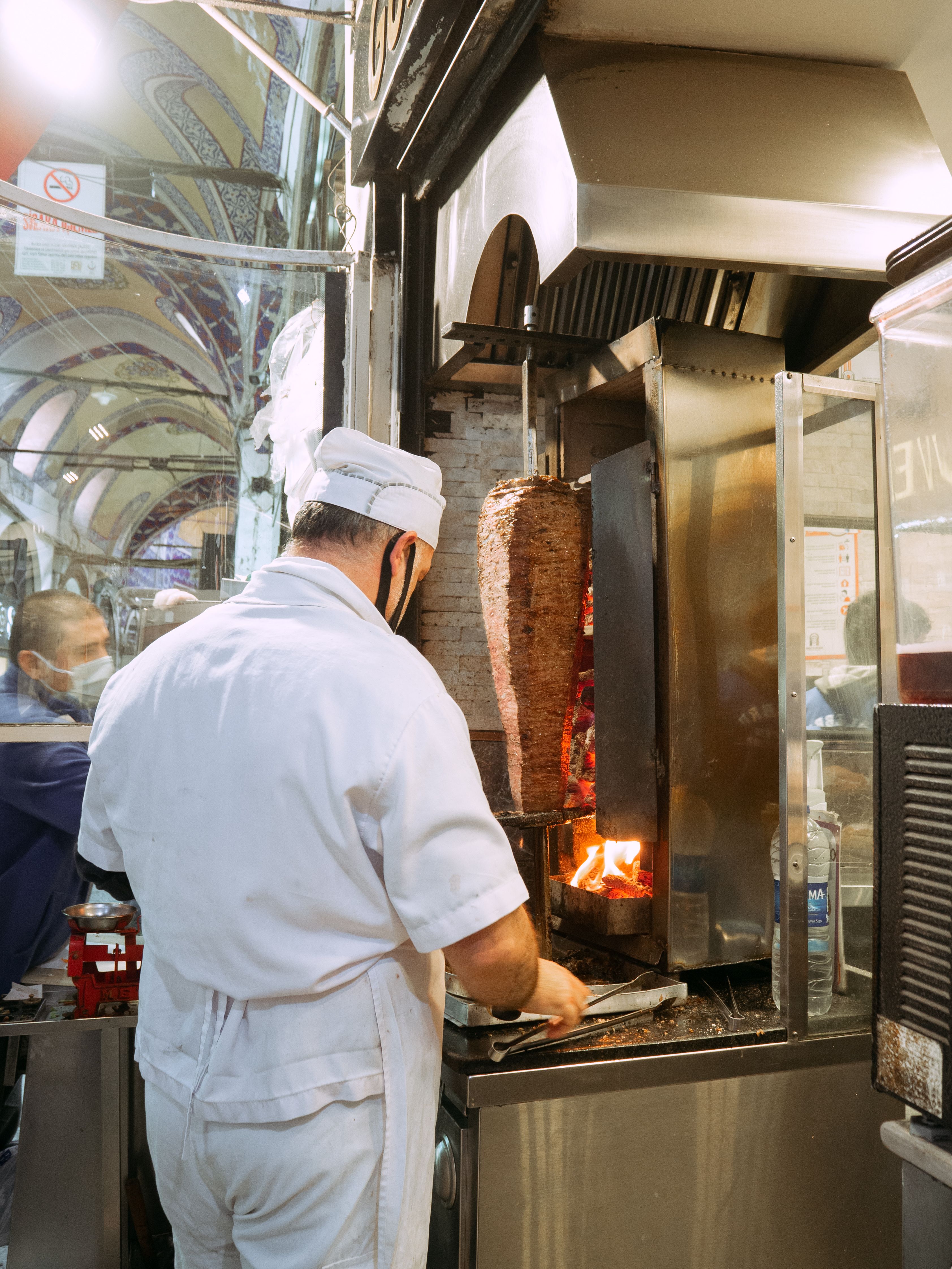 A Man Standing Near the Gyros Grill · Free Stock Photo
