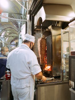Chef prepares authentic döner kebab in Istanbul's iconic marketplace.