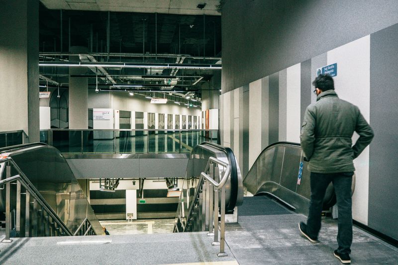 A man descends an escalator in an Istanbul metro station, capturing modern urban transit.