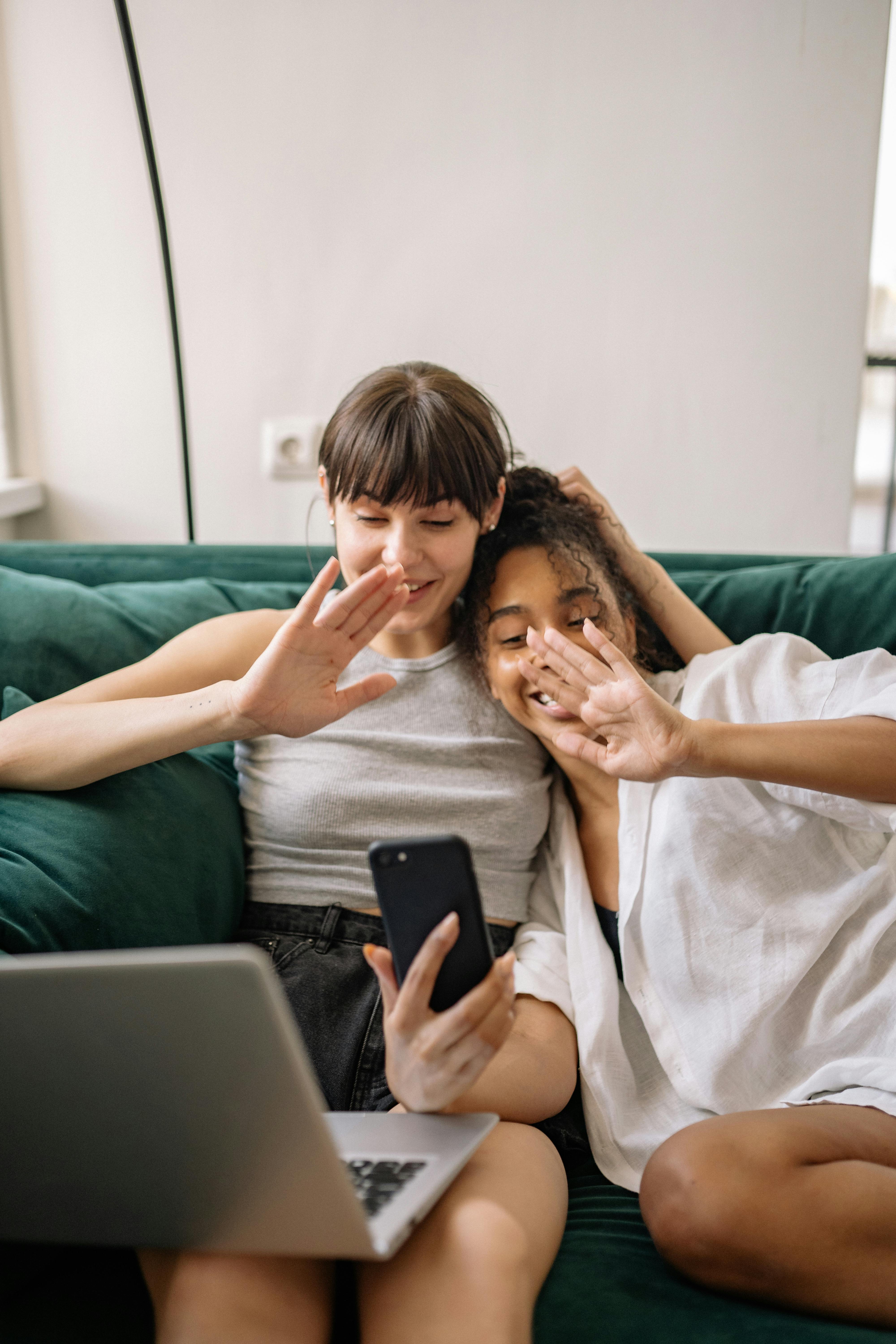 Women Sitting on the Couch Engaged in a picture