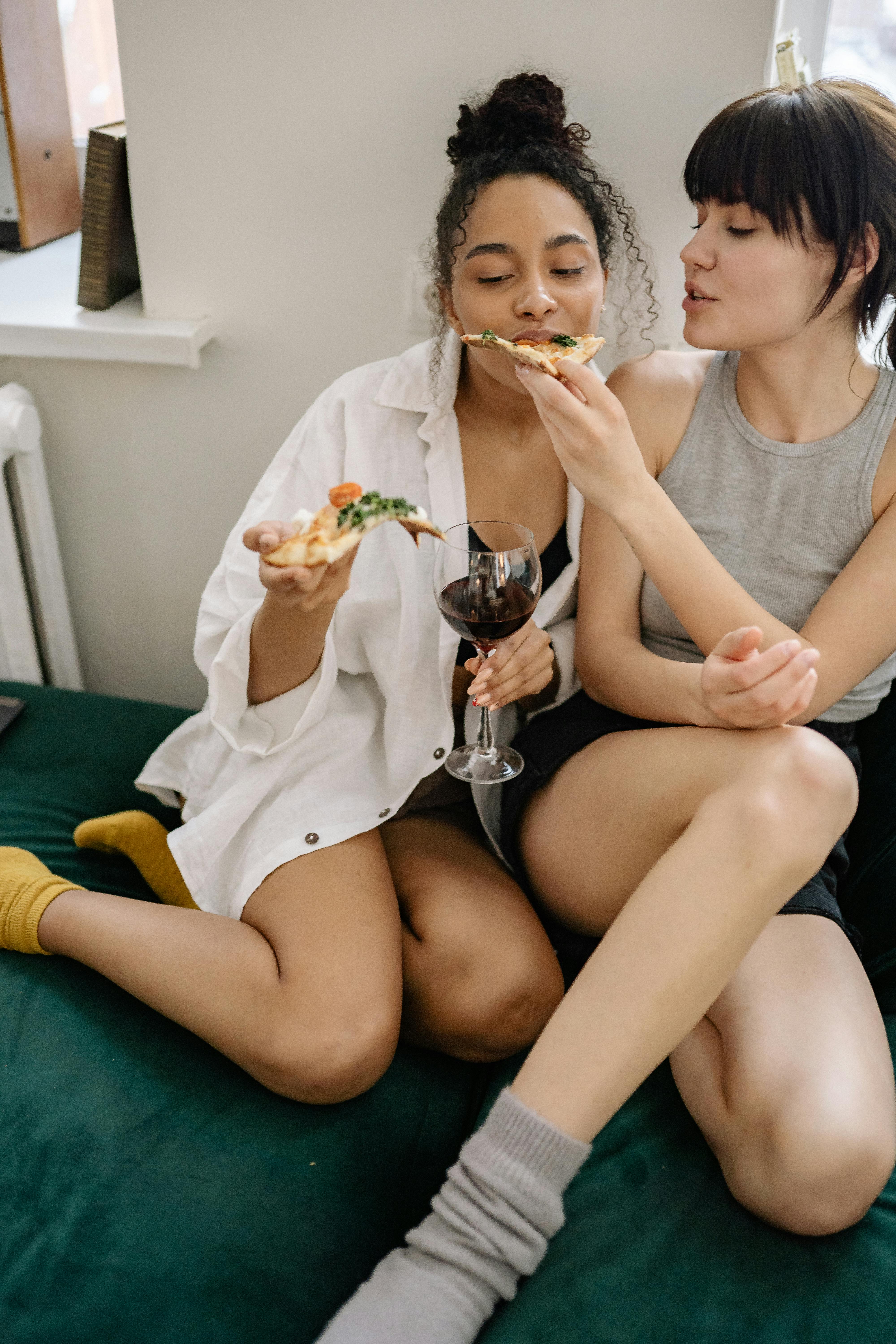 a couple eating pizza
