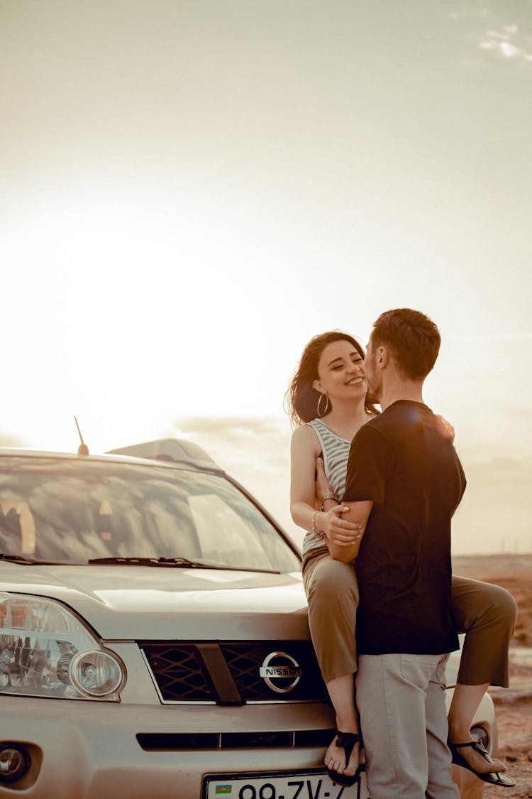 Happy Couple Hugging Near Car