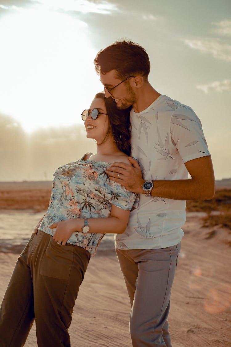 Loving Couple Cuddling On Sandy Beach