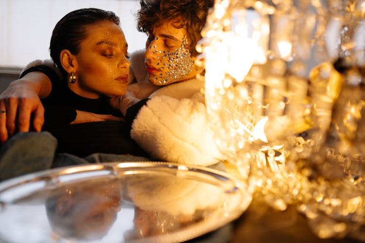 Couple Sitting Near A Silver Plate And Chandelier