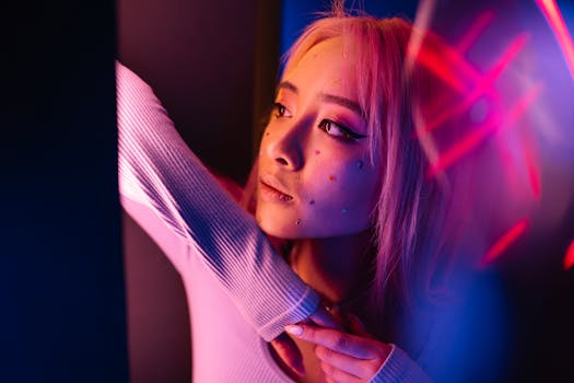 Artistic close-up of a woman with creative makeup and neon lighting, expressing vibrant style.