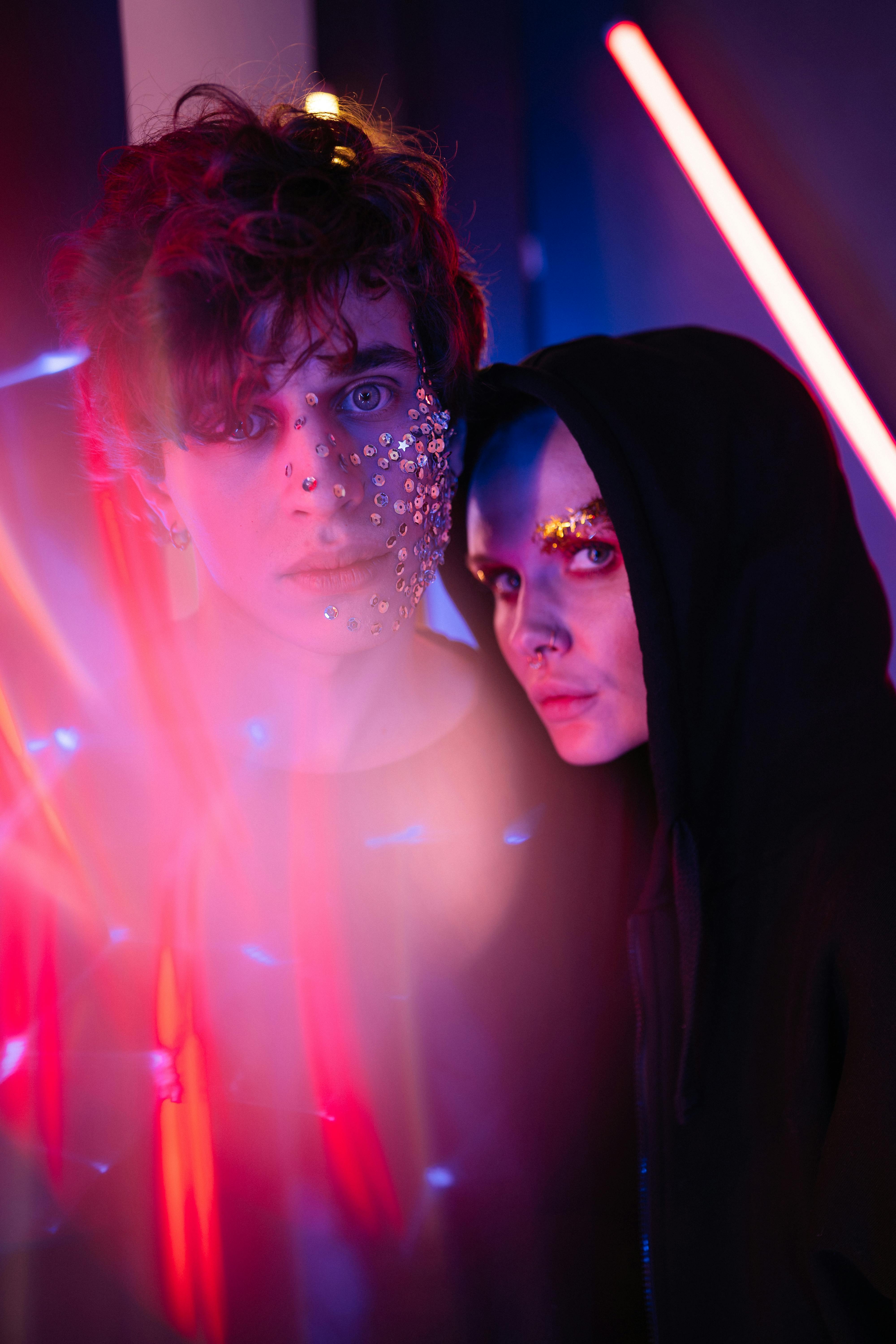 a man and a woman with glitters on face