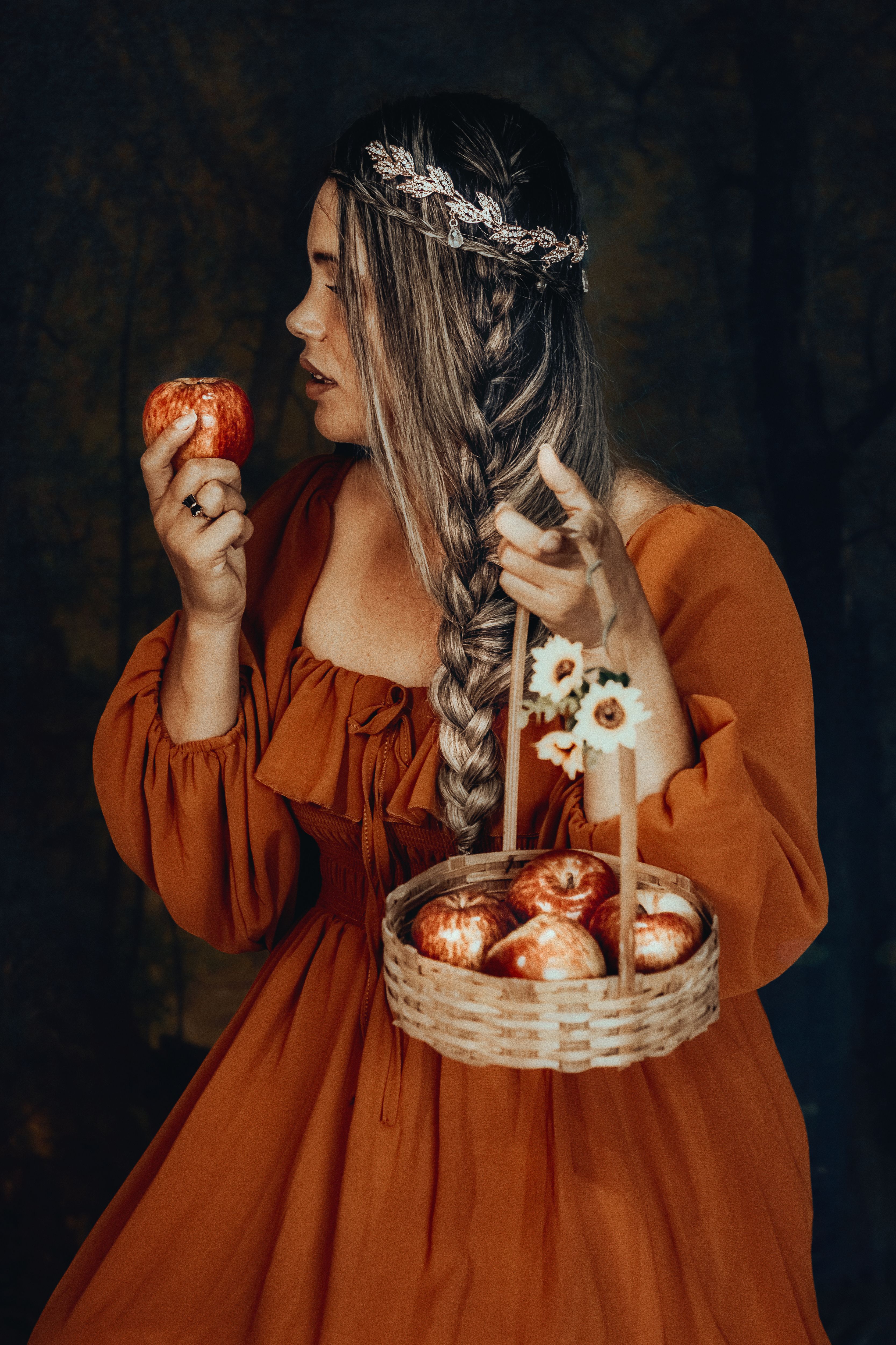 A Woman in an Orange Dress Holding a Basket of Apples · Free Stock Photo