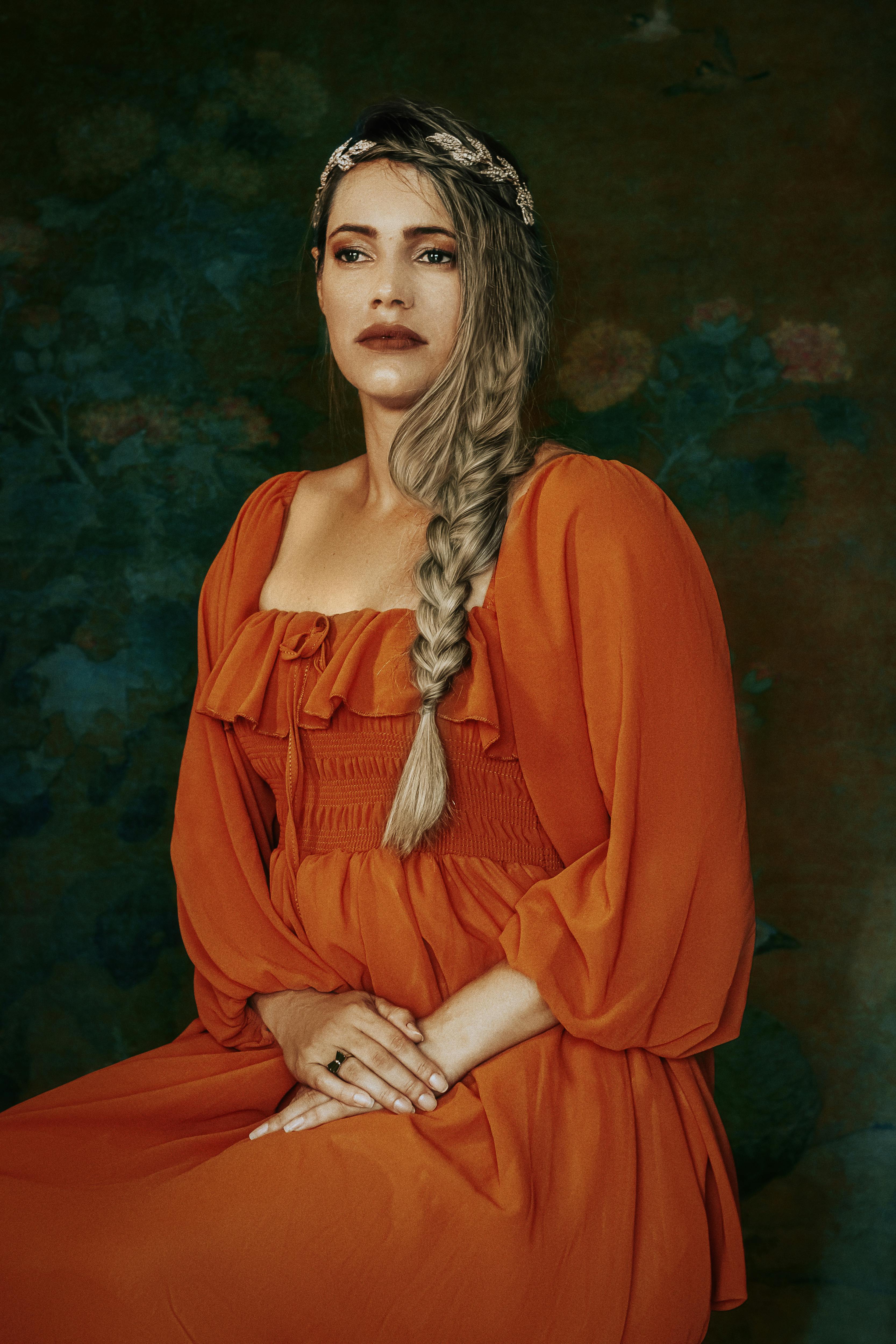 a woman with braided hair sitting