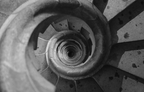 Free Top view of a spiral staircase in a historic Barcelona building, showcasing geometric patterns. Stock Photo