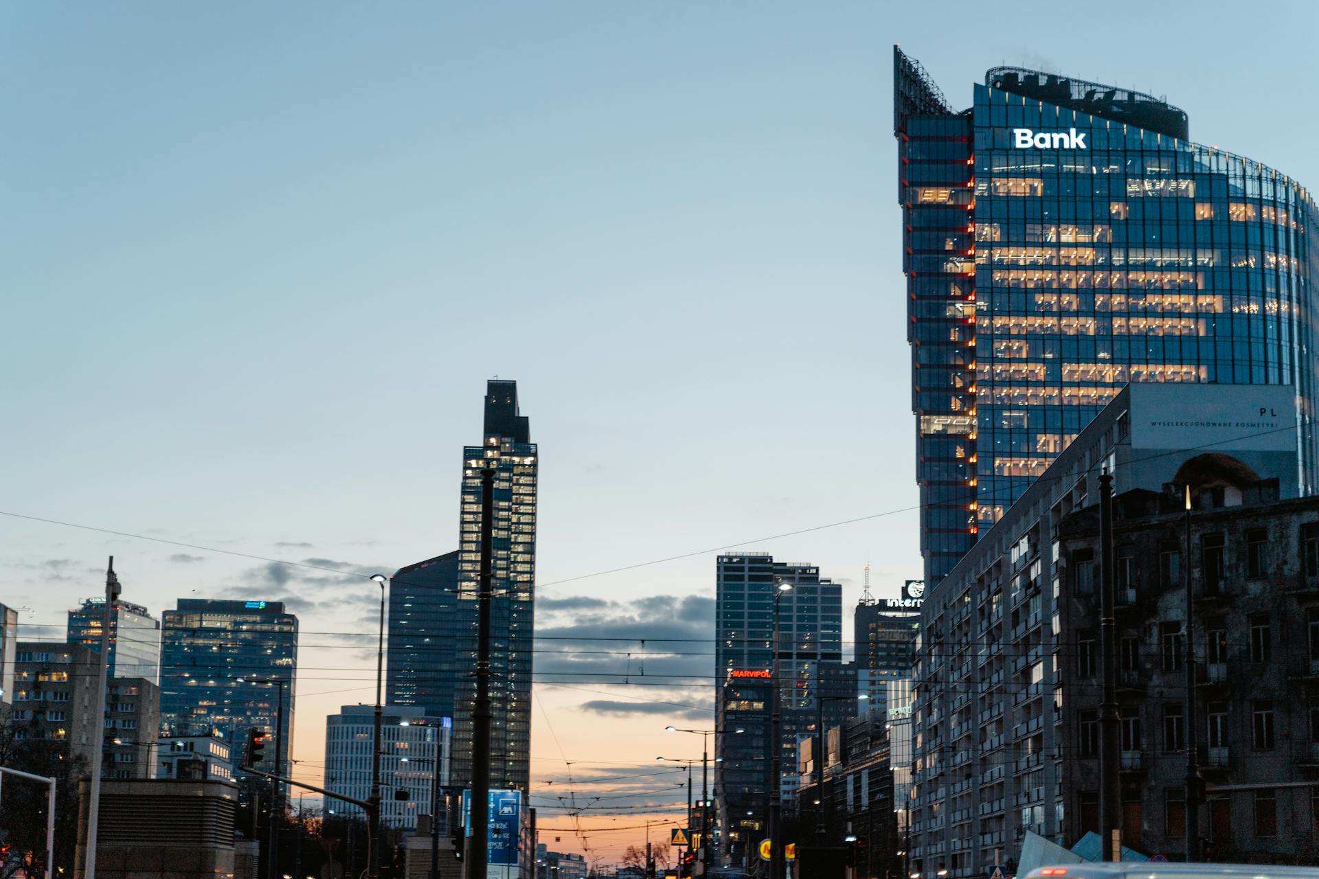 A contemporary city skyline featuring tall buildings and a prominent bank at dusk.