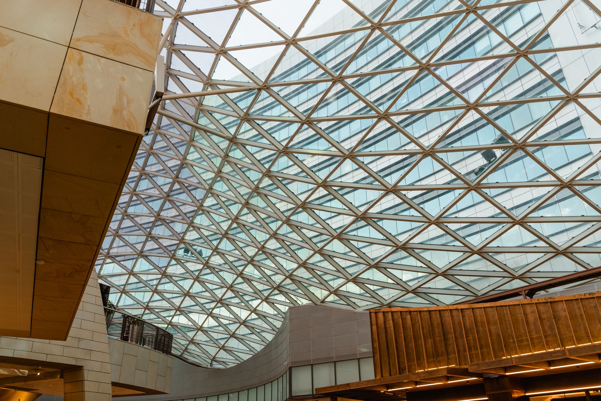 Futuristic glass dome interior with geometric patterns in a commercial building.