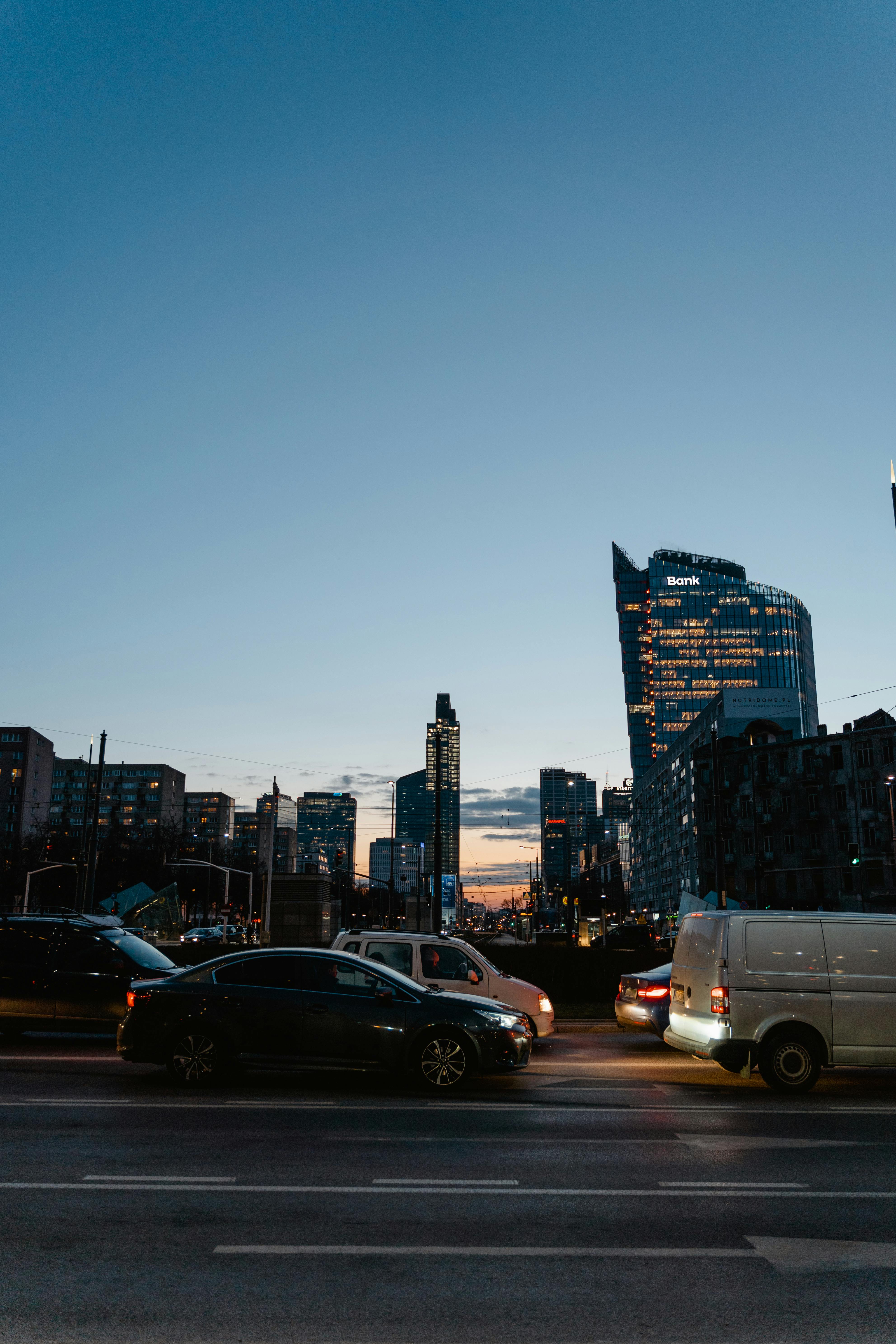 cars on road near high rise buildings