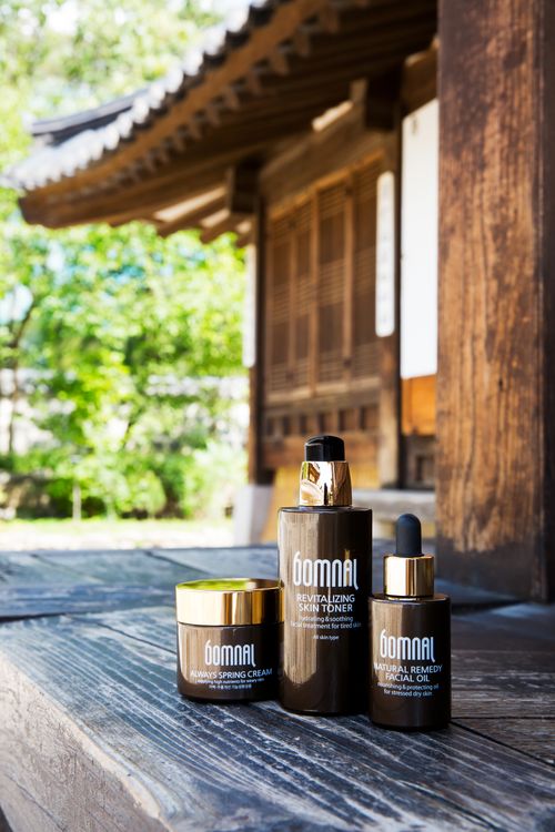 Free High-quality Korean skincare products displayed outdoors against a traditional architecture backdrop. Stock Photo