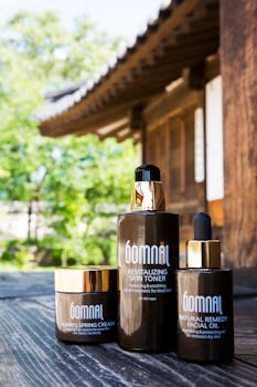 Revitalizing skin care products displayed in a serene outdoor setting with a traditional wooden structure.