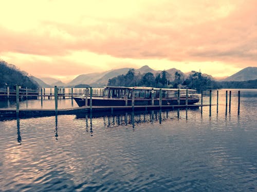 Boat Beside Dock during Golden Hour