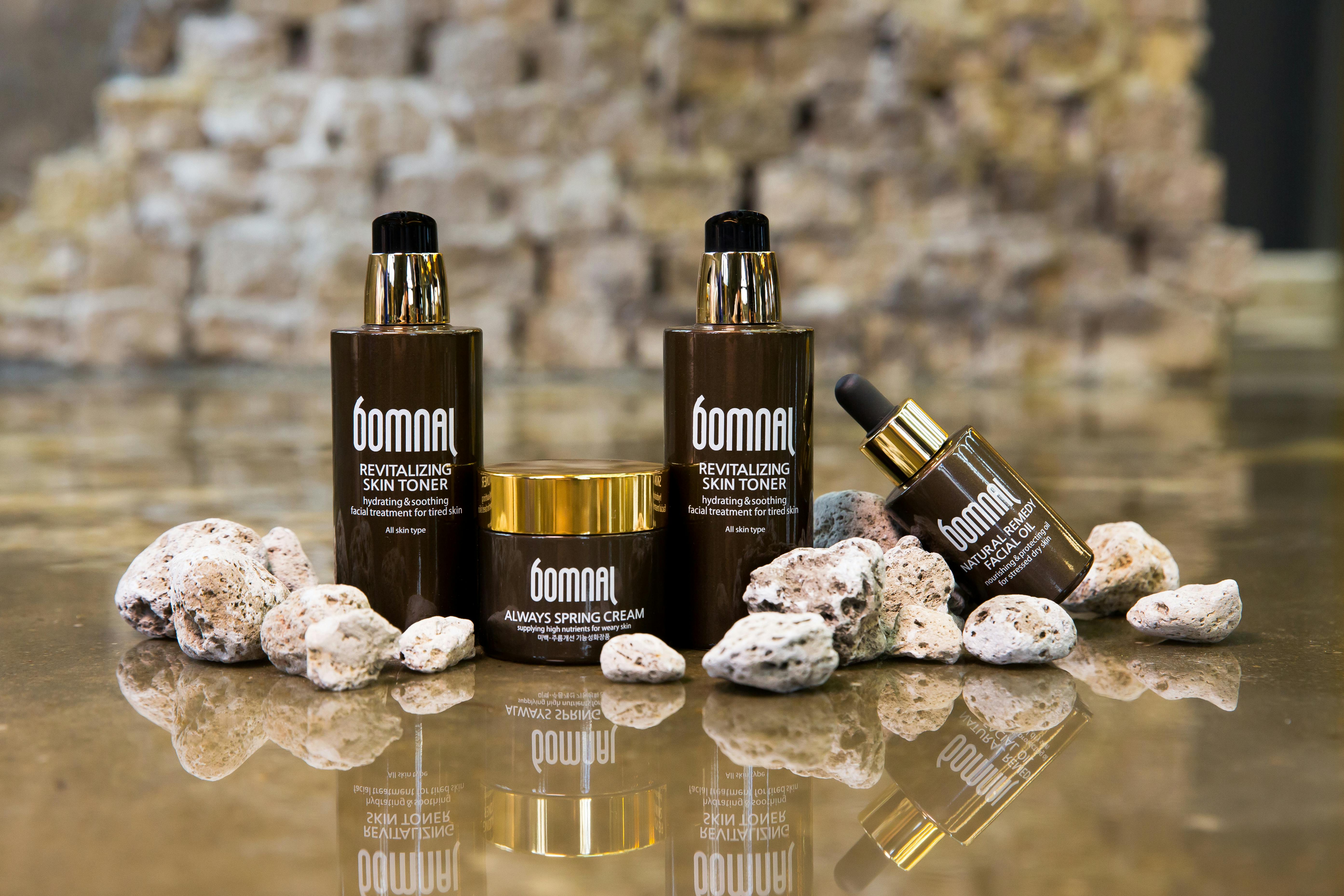 Elegant skincare product setup with reflective surface, ideal for beauty ads.