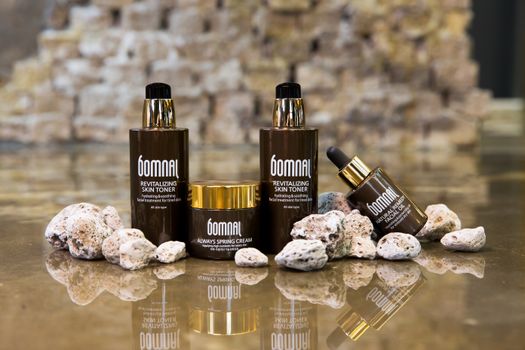 Elegant skincare product setup with reflective surface, ideal for beauty ads.