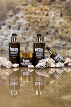 Elegant skincare products displayed with natural stones in a reflective composition.