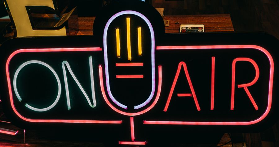 Neon on-air sign in a recording booth — photo by Meruyert Gonullu on Pexels