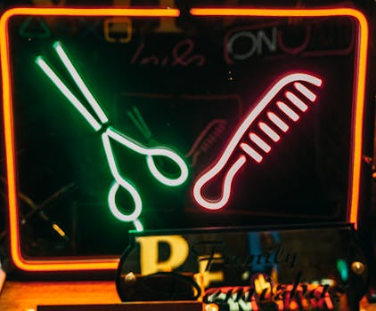 Vibrant neon sign of scissors and comb in Istanbul's bustling area at night.