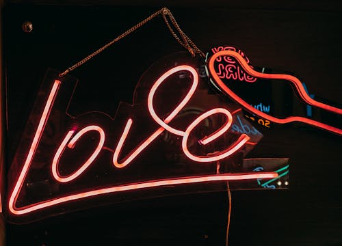 Free A Love Neon Signage Hanging on a Glass Door Stock Photo