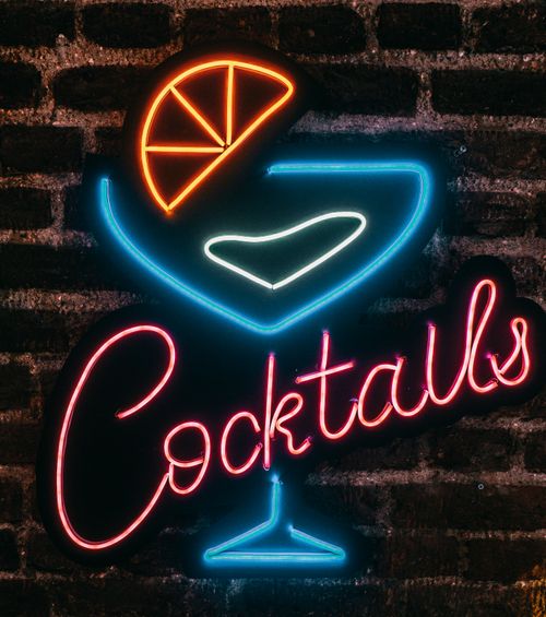 Free Vibrant neon cocktails sign glowing on a brick wall at night in Istanbul, Turkey. Stock Photo