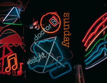 Colorful neon signs glowing in an artistic display, creating a vibrant nighttime scene.