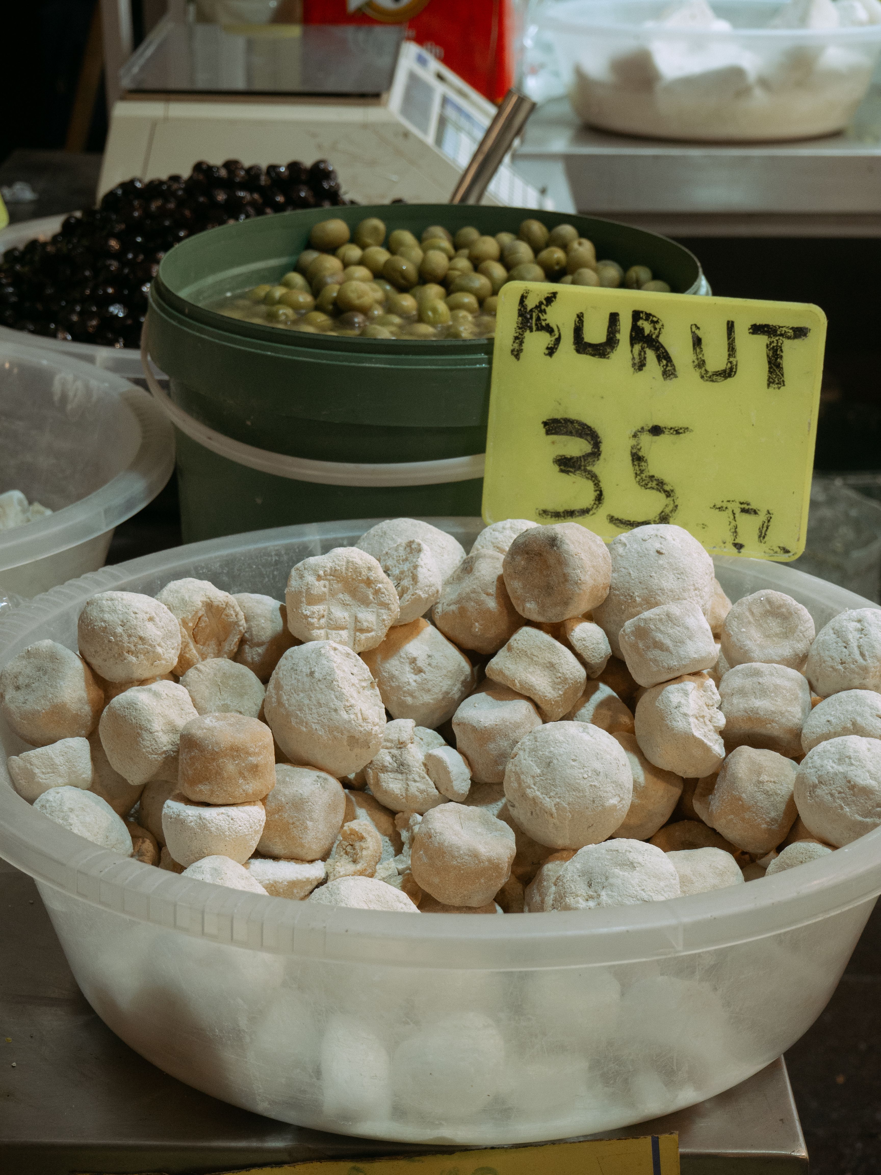 Close-up of traditional kurut cheese balls for sale at a vibrant Istanbul street market.