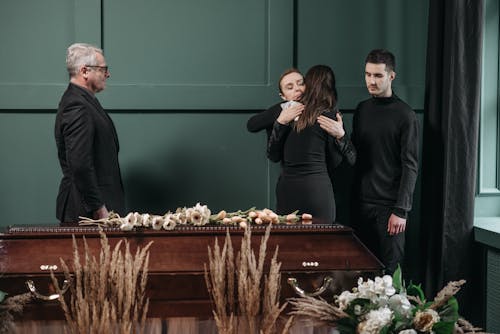 Free A Group of People in Black Clothing Grieving Near a Coffin Stock Photo