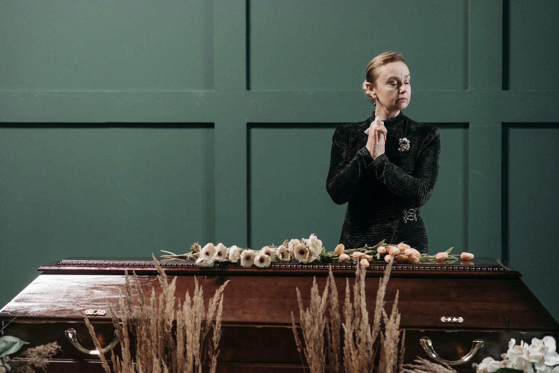 A Woman Standing Beside the Coffin