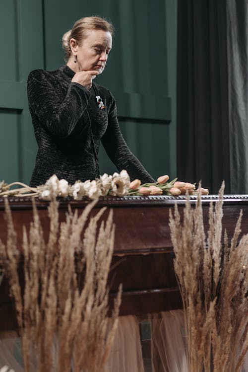 A Woman Standing Beside the Coffin