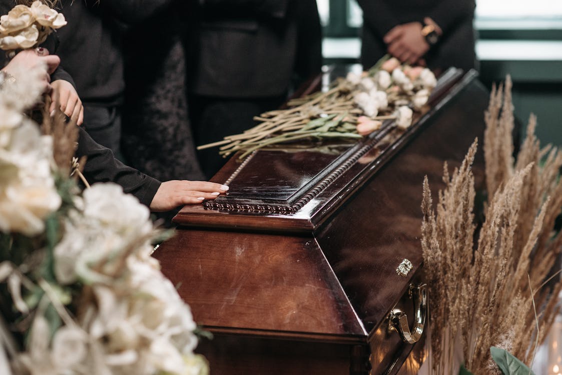 Free A Person Holding a Wooden Coffin Stock Photo
