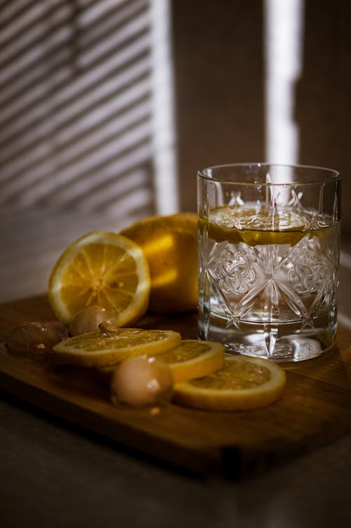 A Clear Drinking Glass Near Sliced Lemon