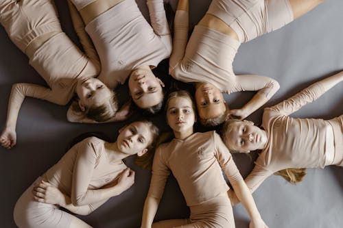 Free Group of Children in Leotards Lying on the Floor  Stock Photo