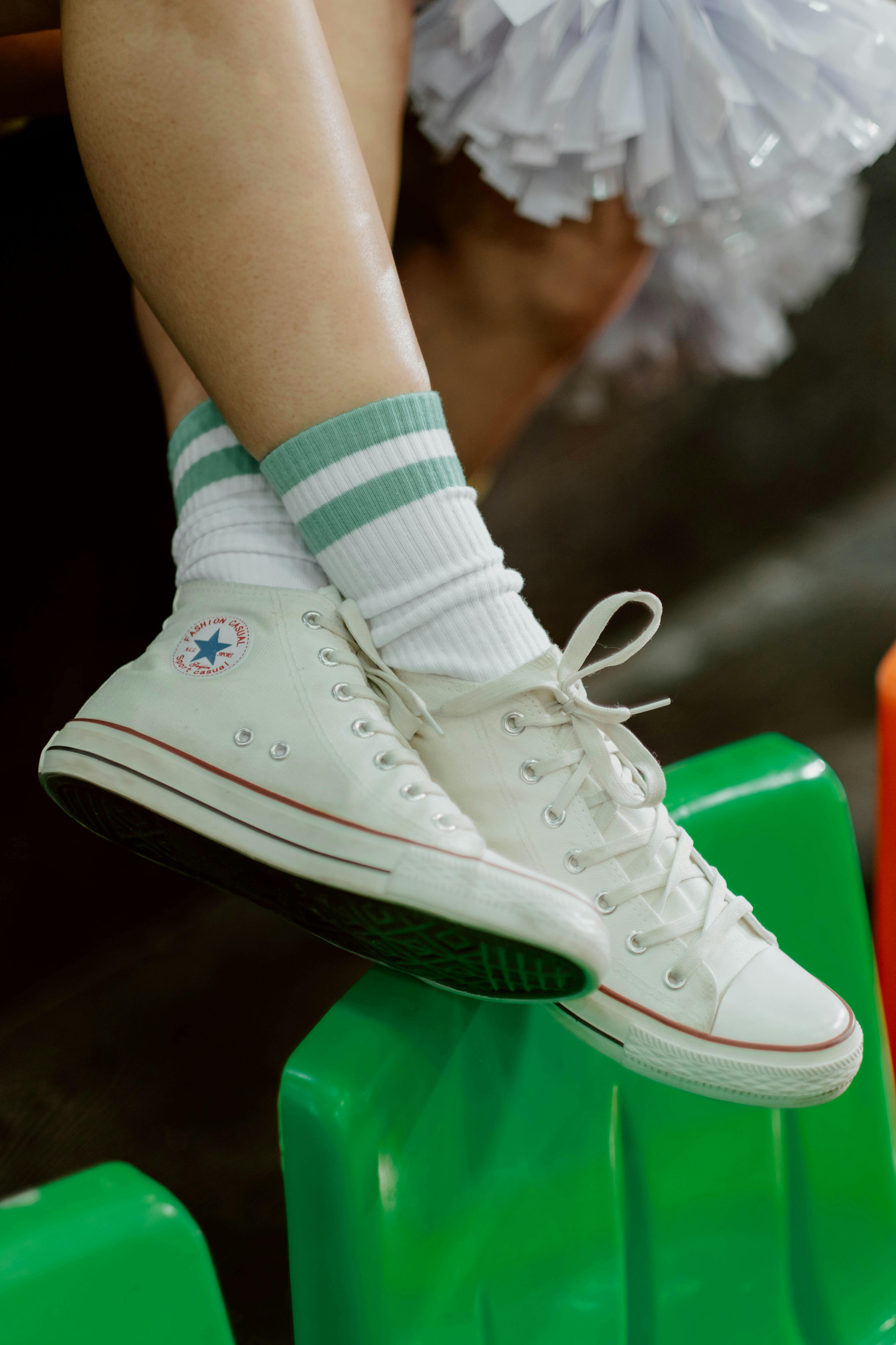A Person Wearing Socks and Sneakers · Free Stock Photo
