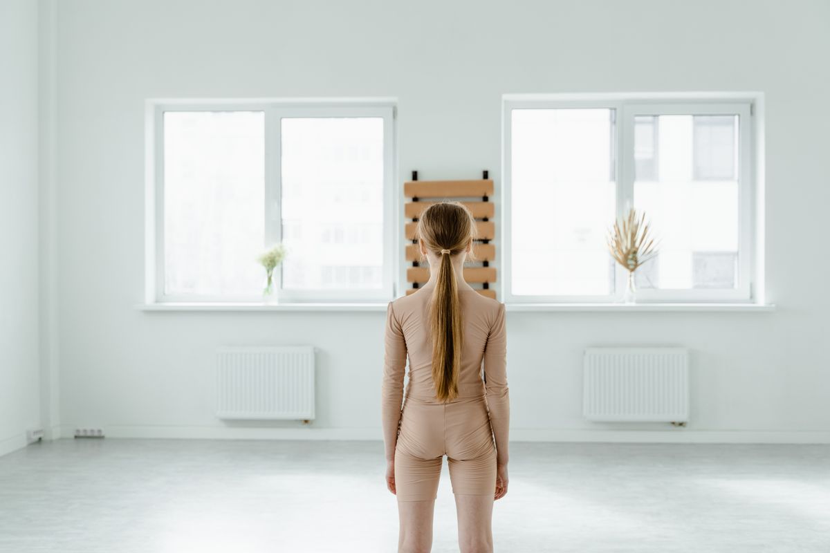 Woman standing with aligned posture, illustrating posture corrector fit