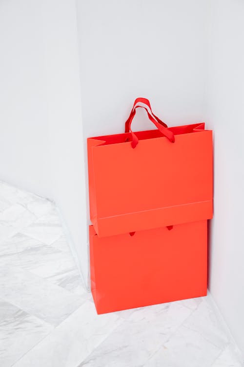 Orange Shopping Bags on White Background