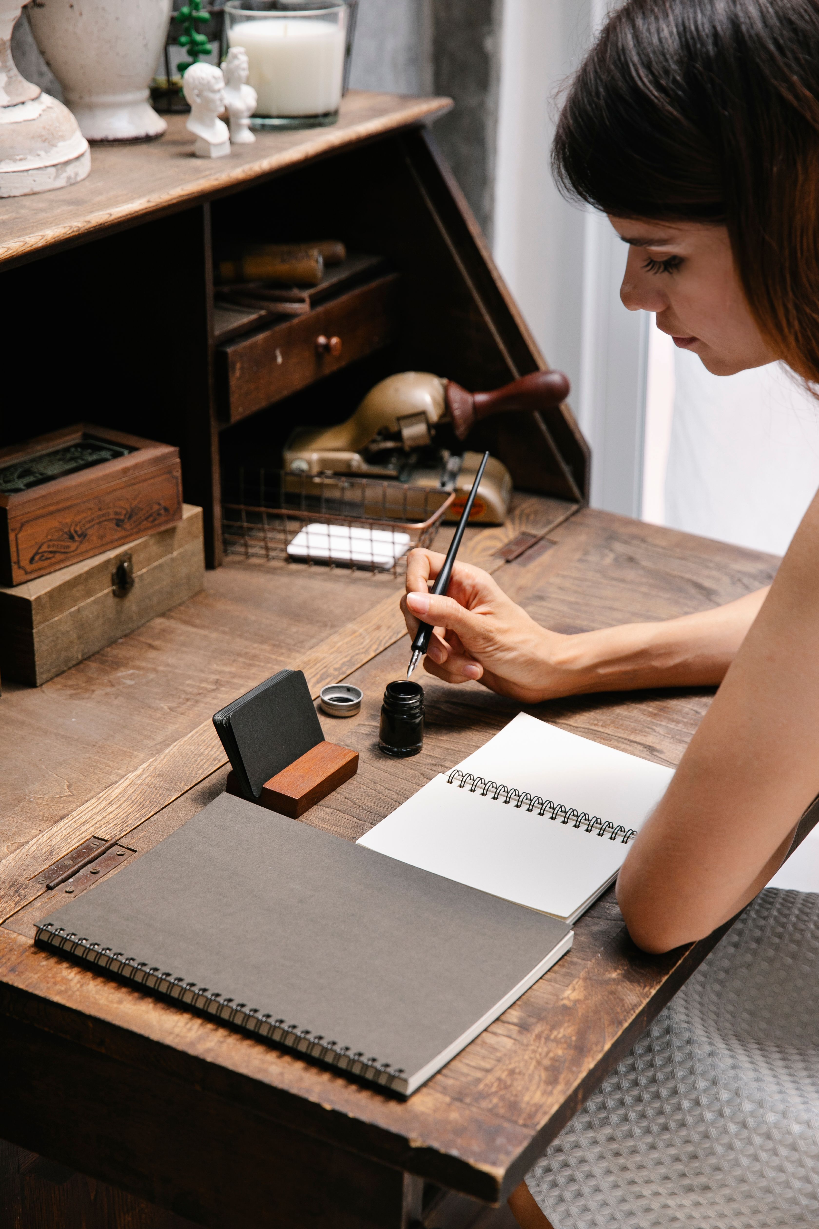 Ink, a pen and the blank page at the desk