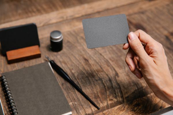 Captured photo of the front of an identity card held over a desk — Angela Roma on Pexels