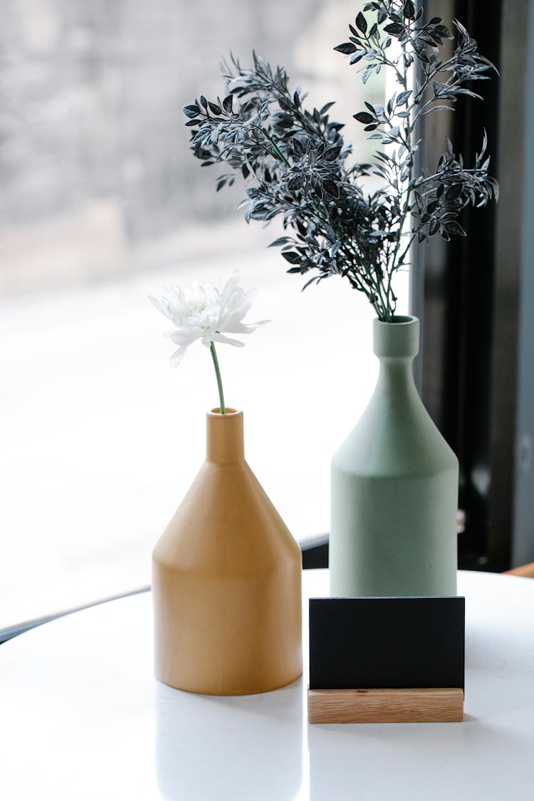 Blooming Flowers On Table With Tent Card Indoors