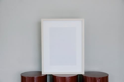 Blank photo frame on blocks on gray background