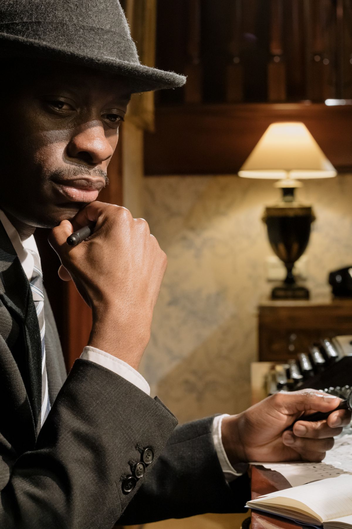 Investigator sitting in a quiet office, thinking through a case